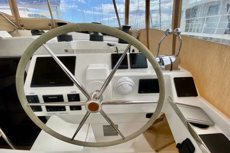  Yacht Photos Pics 2024 Fountaine Pajot Catamaran Aura 51 helm with modern navigation instruments.