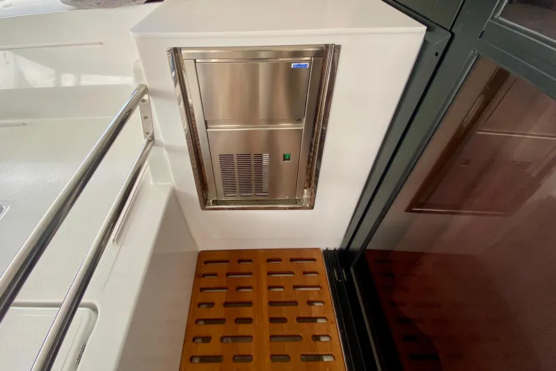  Yacht Photos Pics 2024 Fountaine Pajot Catamaran Aura 51 interior with stainless steel appliance and wooden flooring.