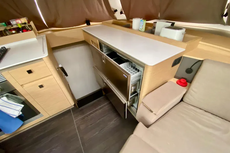  Yacht Photos Pics 2024 Fountaine Pajot Catamaran Aura 51 interior kitchen with modern appliances and sleek design.
