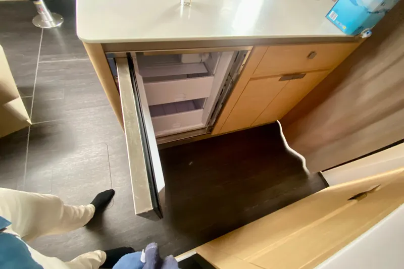  Yacht Photos Pics Interior view of 2024 Fountaine Pajot Catamaran Aura 51, featuring an open refrigerator.