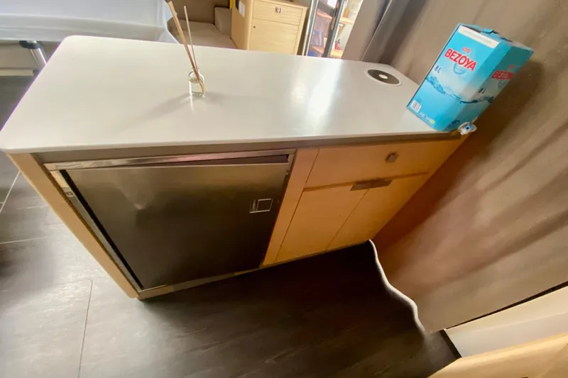  Yacht Photos Pics Interior of 2024 Fountaine Pajot Catamaran Aura 51, featuring a compact kitchen area.