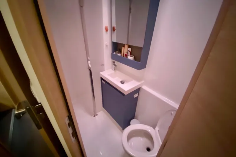  Yacht Photos Pics Bathroom interior of 2024 Fountaine Pajot Catamaran Aura 51, featuring modern fixtures.
