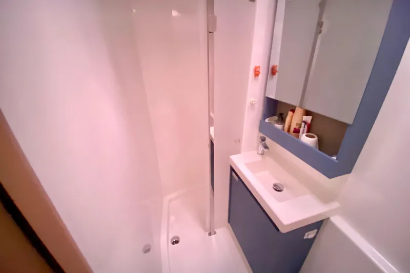 Yacht Photos Pics Modern bathroom in 2024 Fountaine Pajot Catamaran Aura 51, featuring sleek design and amenities.