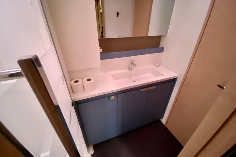  Yacht Photos Pics 2024 Fountaine Pajot Catamaran Aura 51 bathroom with modern sink and storage.