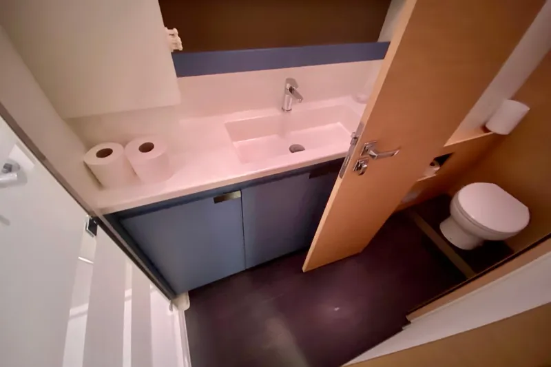  Yacht Photos Pics 2024 Fountaine Pajot Aura 51 Catamaran bathroom with modern sink and toilet.