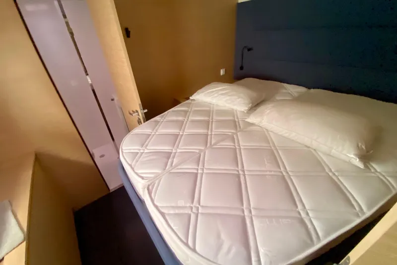  Yacht Photos Pics 2024 Fountaine Pajot Catamaran Aura 51 cabin with bed and modern interior design.