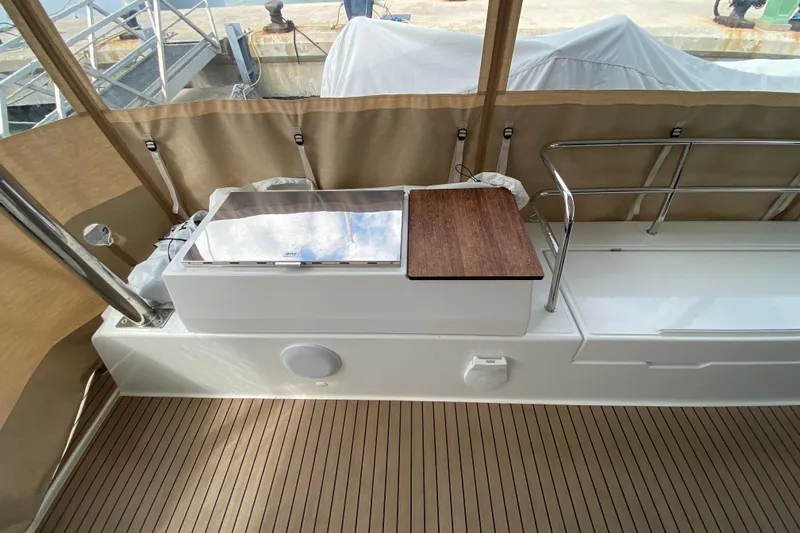  Yacht Photos Pics 2024 Fountaine Pajot Catamaran Aura 51 deck with wood accents and railing.