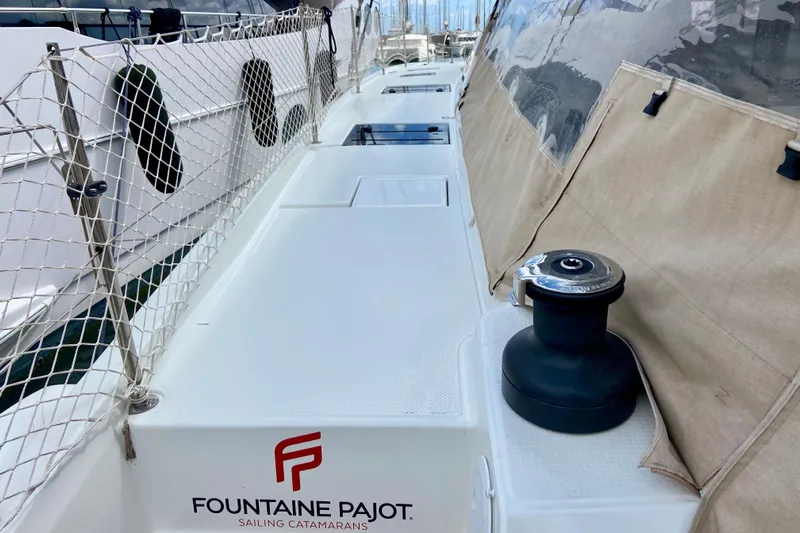  Yacht Photos Pics 2024 Fountaine Pajot Catamaran Aura 51 deck with winch and safety netting.