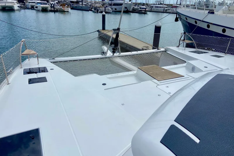  Yacht Photos Pics 2024 Fountaine Pajot Catamaran Aura 51 docked at marina, showcasing spacious deck.