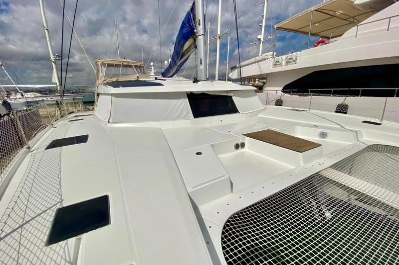  Yacht Photos Pics 2024 Fountaine Pajot Catamaran Aura 51 docked, showcasing sleek design and spacious deck.