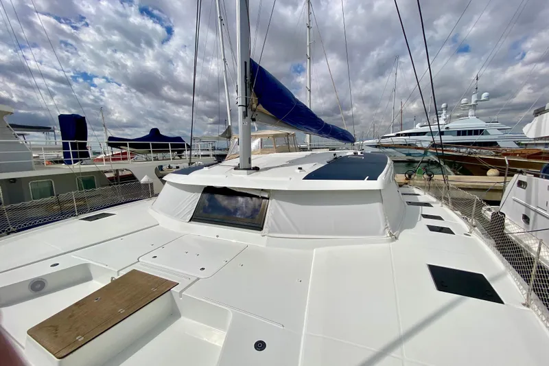  Yacht Photos Pics 2024 Fountaine Pajot Catamaran Aura 51 docked, showcasing sleek design and spacious deck.