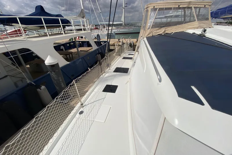  Yacht Photos Pics 2024 Fountaine Pajot Catamaran Aura 51 docked, showcasing sleek design and spacious deck.