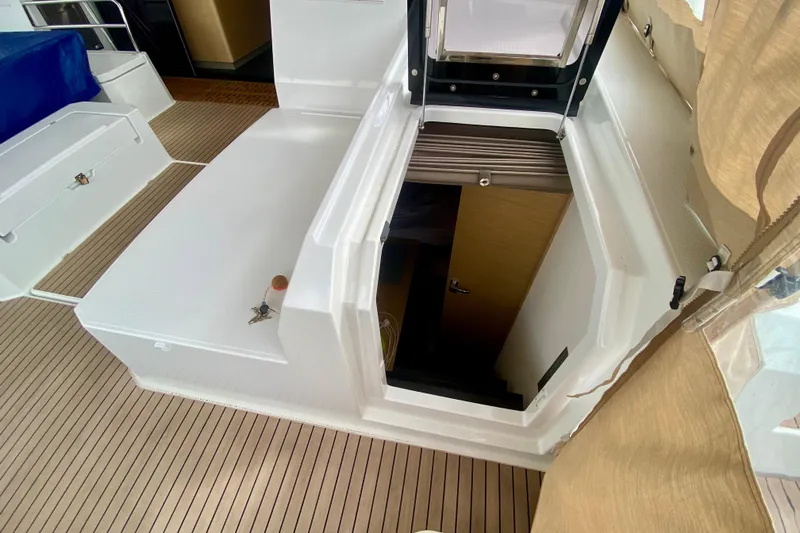  Yacht Photos Pics 2024 Fountaine Pajot Catamaran Aura 51 interior stairway with wooden flooring.