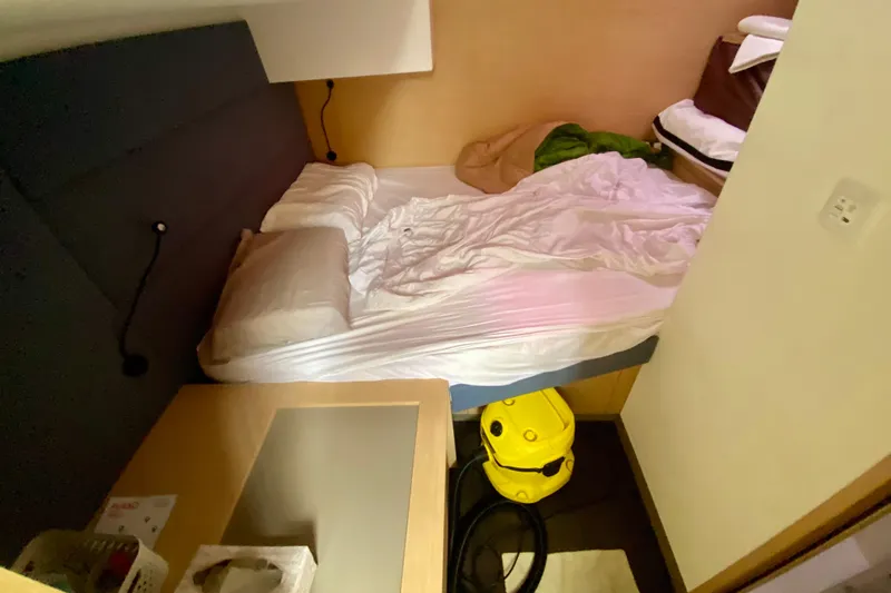  Yacht Photos Pics Cozy cabin interior of 2024 Fountaine Pajot Catamaran Aura 51 with bed and storage.