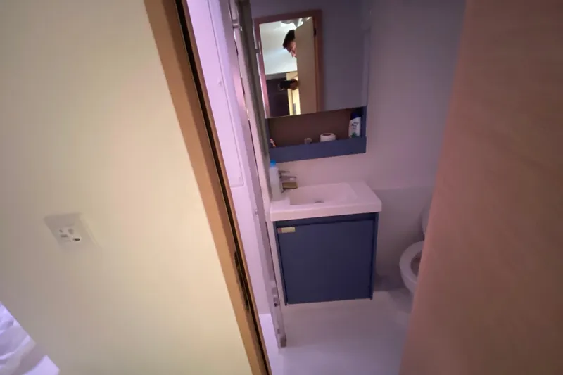  Yacht Photos Pics Bathroom interior of 2024 Fountaine Pajot Catamaran Aura 51, featuring modern sink and mirror.