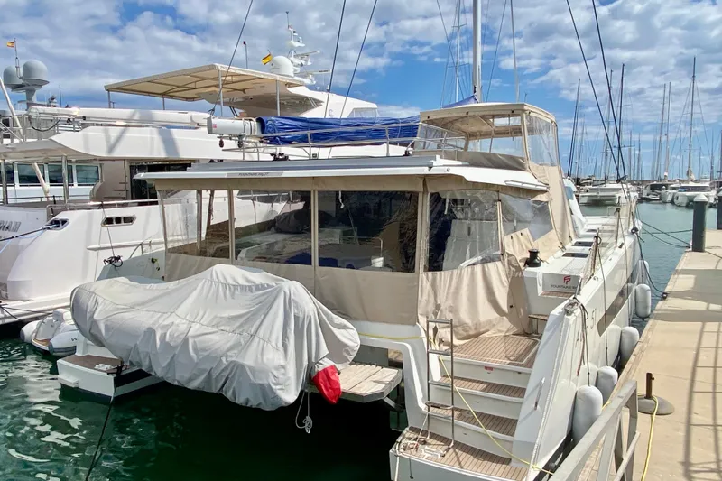  Yacht Photos Pics 2024 Fountaine Pajot Catamaran Aura 51 docked at marina under cloudy sky.