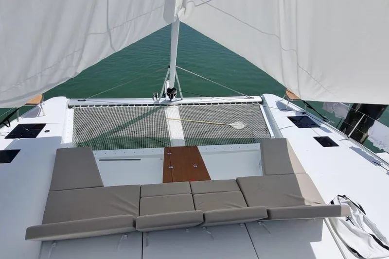 Yacht Photos Pics 2024 Fountaine Pajot Catamaran Aura 51 deck with seating and netting over water.