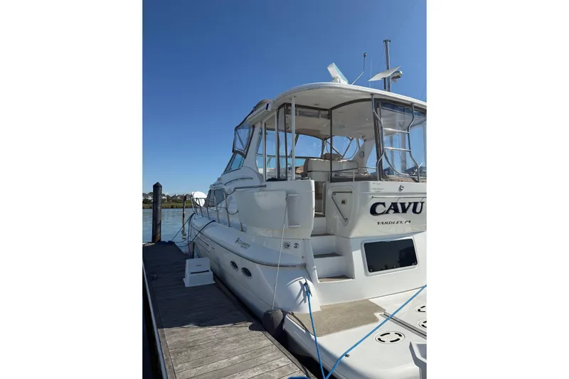 Cavu Yacht Photos Pics 2001 Cruisers 4450 ACMY yacht docked, featuring spacious deck and clear skies.