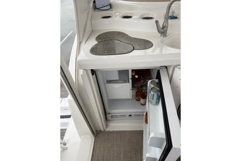 Cavu Yacht Photos Pics 2001 Cruisers 4450 ACMY yacht kitchenette with open mini fridge and sink.