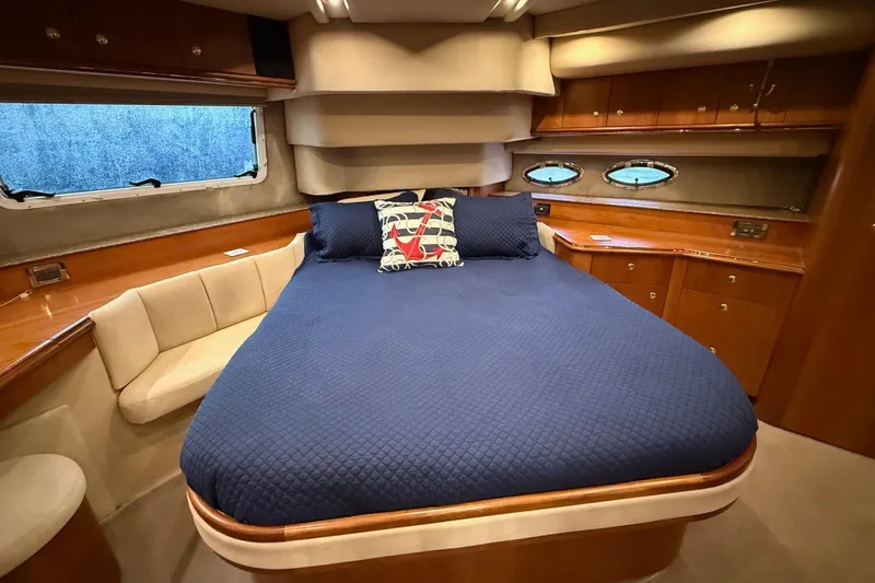 Cavu Yacht Photos Pics Luxurious cabin interior of 2001 Cruisers 4450 ACMY yacht with blue bedding.