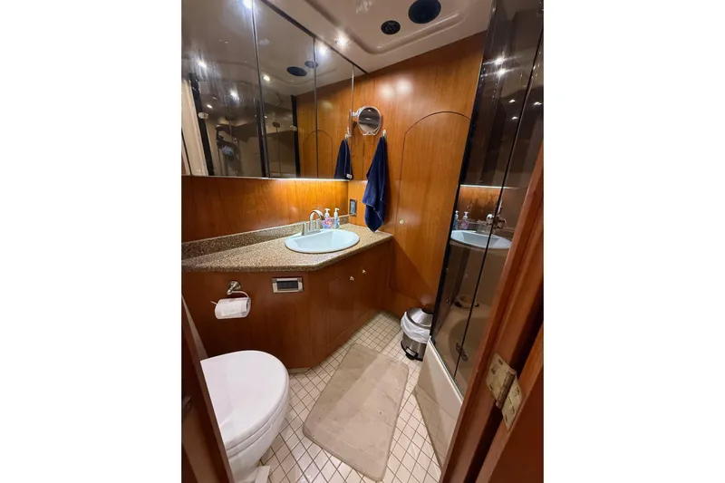 Cavu Yacht Photos Pics Luxurious 2001 Cruisers 4450 ACMY yacht bathroom with wood accents and modern fixtures.