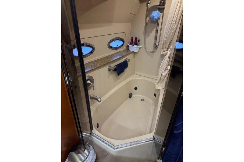 Cavu Yacht Photos Pics Bathroom interior of 2001 Cruisers 4450 ACMY yacht with shower and portholes.