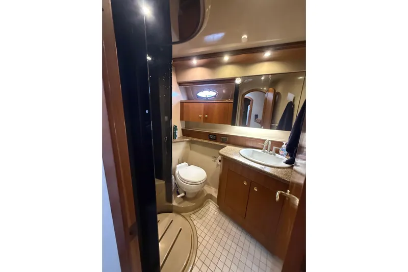 Cavu Yacht Photos Pics Luxurious bathroom in 2001 Cruisers 4450 ACMY yacht with modern amenities.