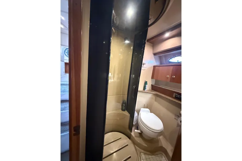 Cavu Yacht Photos Pics Bathroom interior of 2001 Cruisers 4450 ACMY yacht with shower and toilet.