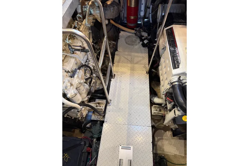 Cavu Yacht Photos Pics Engine room of 2001 Cruisers 4450 ACMY yacht with visible machinery and equipment.