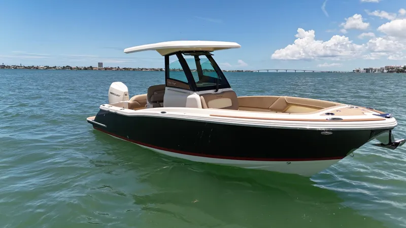  Yacht Photos Pics 2024 Chris-Craft Catalina 24 boat on calm water under a clear blue sky.