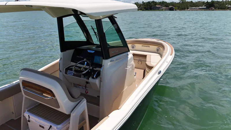  Yacht Photos Pics 2024 Chris-Craft Catalina 24 boat on calm water, featuring sleek design and modern controls.