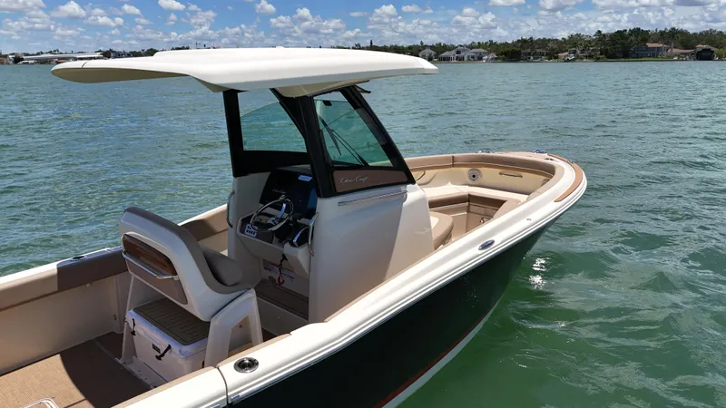  Yacht Photos Pics 2024 Chris-Craft Catalina 24 boat on calm water under a clear sky.