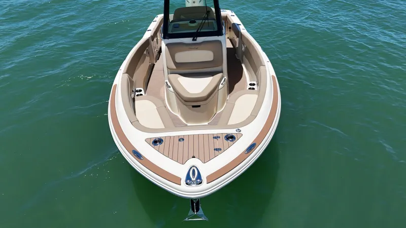  Yacht Photos Pics 2024 Chris-Craft Catalina 24 boat on calm water, showcasing elegant design and spacious seating.