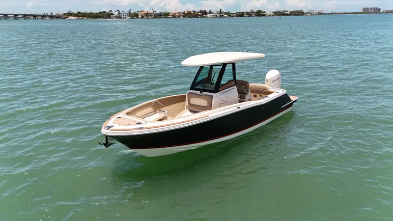  Yacht Photos Pics 2024 Chris-Craft Catalina 24 boat on calm blue water, showcasing sleek design and luxury features.