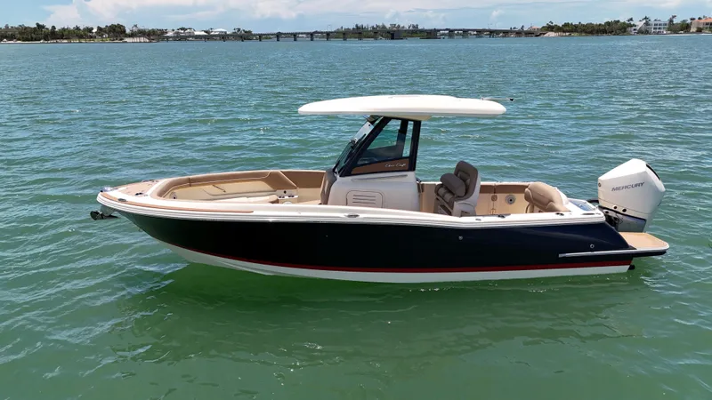  Yacht Photos Pics 2024 Chris-Craft Catalina 24 boat on calm water, featuring sleek design and Mercury outboard engine.