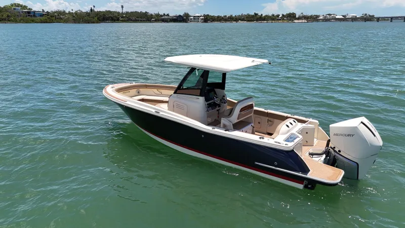  Yacht Photos Pics 2024 Chris-Craft Catalina 24 boat on calm water, featuring sleek design and Mercury outboard engine.