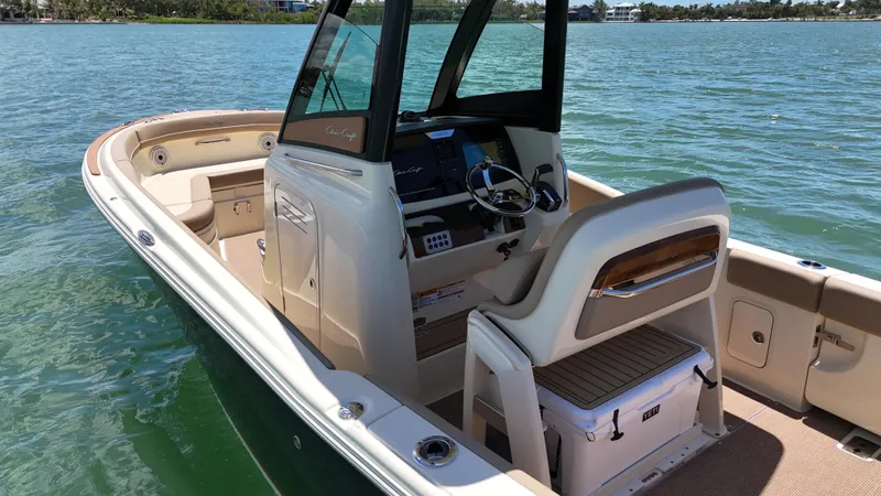  Yacht Photos Pics 2024 Chris-Craft Catalina 24 boat interior with helm and seating on water.