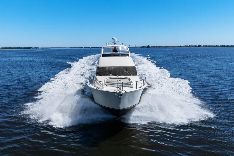  Yacht Photos Pics Lazzara yacht cruising on open water under clear blue sky.
