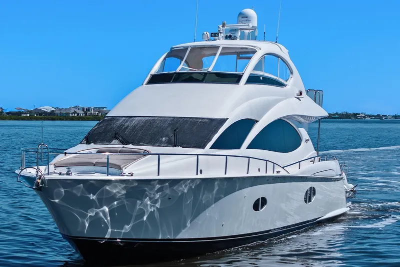  Yacht Photos Pics Luxurious Lazzara yacht cruising on a clear blue sea under a bright sky.