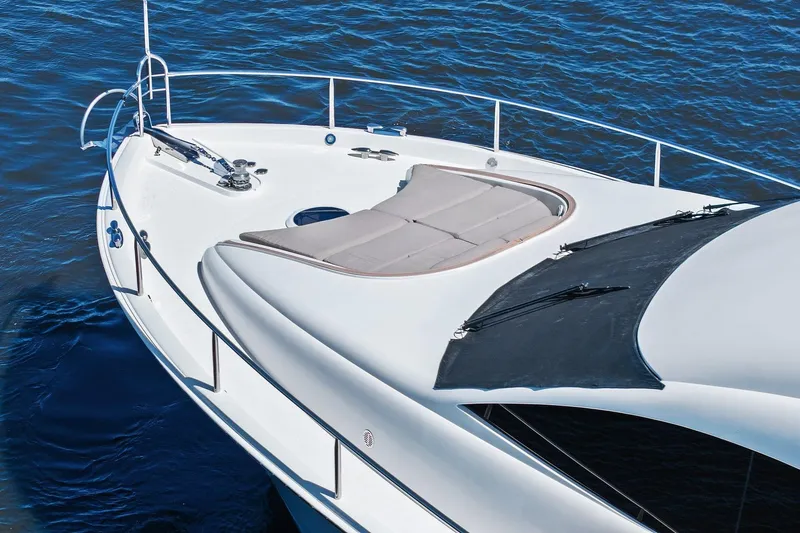  Yacht Photos Pics Luxurious Lazzara yacht deck with sunbathing area on calm blue water.