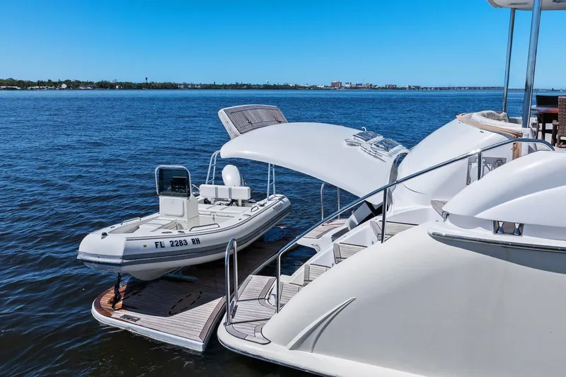  Yacht Photos Pics Luxury Lazzara yacht with tender boat on calm blue waters.