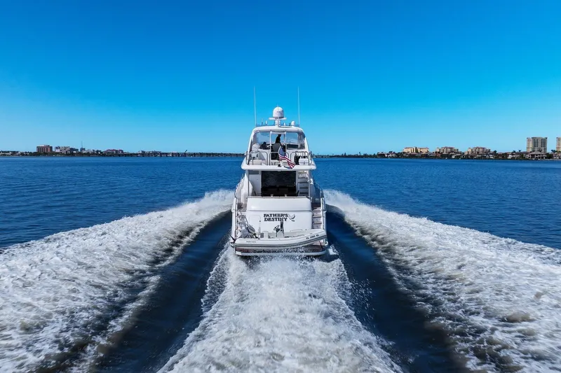  Yacht Photos Pics Lazzara yacht cruising on open water, leaving a wake under clear blue skies.