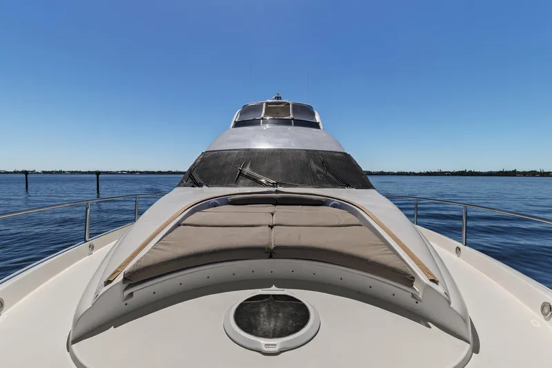  Yacht Photos Pics Luxury Lazzara yacht with sunbathing deck on calm blue waters.