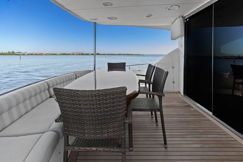  Yacht Photos Pics Outdoor seating area on a Lazzara yacht with ocean view and wicker chairs.