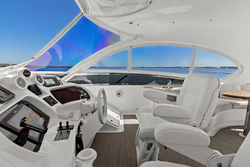  Yacht Photos Pics Luxurious Lazzara yacht cockpit with white leather seating and panoramic ocean view.