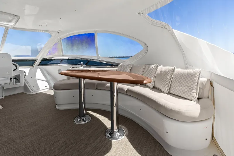  Yacht Photos Pics Luxurious Lazzara yacht interior with curved seating, elegant table, and panoramic windows.