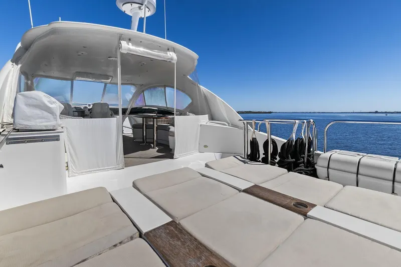  Yacht Photos Pics Luxury Lazzara yacht deck with seating, overlooking serene blue waters.