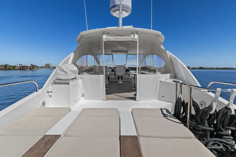  Yacht Photos Pics Luxury Lazzara yacht deck with sun loungers, overlooking calm blue waters.