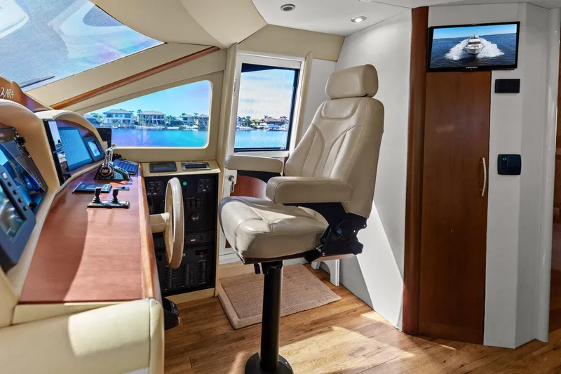  Yacht Photos Pics Luxurious Lazzara yacht helm with leather captain's chair and advanced navigation controls.