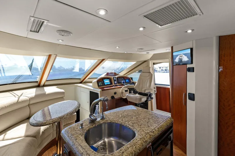  Yacht Photos Pics Luxurious Lazzara yacht interior with helm, granite countertop, and panoramic windows.